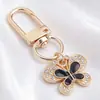 Llavero de Mariposa de Esmalte Blanco y Negro de Gama Alta, Colgante Completo de Diamante, Mariposa Combinada con Colgante de Oro, Llavero DIY, Colgante Pequeño