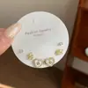 Set de pendientes vintage franceses con flores de perlas y gotas de aceite, exquisito y de lujo ligero, adecuado para el uso diario y versátil para ir al trabajo.