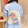 Pantalones Pequeños Frescos de Dibujos Animados con Cordón y Bolsillo con Solapa Fabricante al por Mayor Bolso de Lona Lindo para Mujer 2025 Nuevo Bolso de Lona para Estudiante