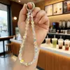 Nuevo Colgante de Cristal Super Brillante Acrílico Bolsa Auriculares Bluetooth Colgante Pequeño Llavero de Coche Cadena para Teléfono Móvil Venta al por Mayor