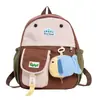 Mochila de moda coreana con bloques de color para niños y niñas, linda con colgante de pez pequeño, monedero, mochila infantil con cara de caricatura