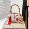 Bolso cheongsam retro de estilo chino con nuevo cierre de broche 2026 bolso de hombro cruzado con cadena de moda bolso de mano para mujer bolso de noche