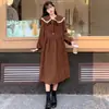 Vestido largo de pana dulce de estilo francés para principios de primavera de 2026, con cinturón para ceñir la cintura, adelgazante, de manga larga, con lazo, estilo preppy para mujer