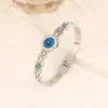 Nova Joia Europeia e Americana de Aço Titânio, Pulseira Olho com Gotejamento de Óleo, Pulseira Oca de Aço Inoxidável Estilo Corte com Turquesa Incrustada