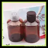 Botella de tapa de mariposa marrón 100ml botella de champú botella de desinfectante de manos 100ml tapa abatible hombro inclinado botella de PET botella de gel