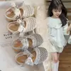 Sandalias de Diadema de Punto Hueco para Niñas 2026 Nuevo Verano Bebé Encaje Lazo Zapatos de Princesa Dulces Zapatos Individuales