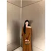 Transmisión en vivo nuevo diseño de otoño sentido de diseño chal adelgazante tipo capa traje de punto de dos piezas falsas