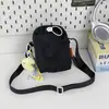 Bolso bandolera mini de color sólido estilo minimalista japonés con letra bordada, nuevo estilo casual para exteriores, bolsa ligera con cordón para botella de agua