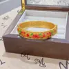 Tienda de oro con nuevo brazalete de color esmalte chino para mujer, brazalete con hebilla de estilo retro de corte, joyería hueca de seda