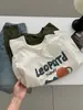 Camiseta Larga de Algodón Cepillado con Estampado de Dibujos Animados Lindos Estilo Coreano para Mujer 2026 Otoño Nueva Holgada Versátil Estilo Ins Superior