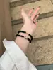 Un Pulsera de Sándalo Negro Iluminada por Piedra Lunar, Suave, Hermosa y Gentil, un Regalo para Manos de Mujer