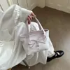 Bolso de mano estampado de nicho súper popular para mujer, nuevo modelo 2026, mini bolso cruzado versátil, bolso tote pequeño para salir