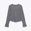 Atacado de Fabricantes de Roupas Femininas Transfronteiriças Novidades 2025 Europeias e Americanas Decote V Manga Longa Decorativo em Camadas Tops Macios, Casuais e Versáteis