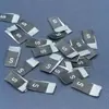 Marca de tejido pliegue marca de tejido marca de número talla general de ropa talla de accesorios etiqueta de tela directo de fábrica comercio exterior se puede fijar