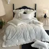 Juego de cuatro piezas de algodón Tencel ultra suave, estilo francés de lujo ligero, femenino, con encaje romántico y juego de sábana y colcha jacquard de alta gama