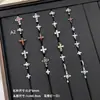Nuevos y modernos aretes de cruz con diamantes completos Jiuhan para mujer, ear cuffs de acero de titanio de nicho, populares tachuelas de hueso de la oreja de alta gama
