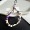 Diseño original de moda en esquema de colores púrpura taro, amuleto para teléfono con diseño de estrella de mar y hueso, cadena para teléfono, cadena para cámara CCD