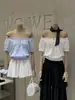 Wgwe9679 Ropa de Mujer Shisanxing Guangzhou 2026 Verano Nuevo Estilo Talla Pequeña Camisa de Hombros Descubiertos de Manga Corta Top Delgado