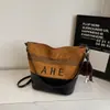 Nova bolsa de camurça listrada 2026, bolsa tote feminina de grande capacidade, estilo casual, bolsa transversal ou de ombro simples