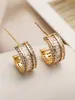 Corea del Sur lujo ligero elegante de moda semicírculo micro incrustación de circón Super flash aretes versátiles aretes de alta calidad que no se decoloran