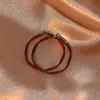 Pendientes Rojos Estilo Retro Hong Kong Electrochapados, Pendientes Elegantes Franceses de Año Nuevo para Mujer, Pendientes de Aleación de Perlas de Alta Gama