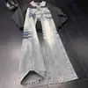 Jeans Retro Americanos de Corte Diagonal para Hombre Primavera, Otoño, Invierno 2026 Pantalones con Estampado de Rayos Estilo High Street Pierna Recta Ligeramente Acampanados