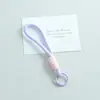 Nuevo cordón para teléfono anudado de bloques de color, llavero DIY hecho a mano, accesorio para bolso, colgante de regalo pequeño, venta al por mayor