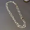 Collar multicapa de trébol de cuatro hojas con perlas y diamantes Cadena larga de suéter retro francés elegante palacio nuevo collar