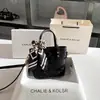 Bolso cubo de moda para el pelo con lazo, bolso de mano bordado de nicho nuevo 2025 al por mayor