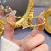 Tienda de oro con pulsera de mariposa azul quemada en arena dorada pulsera de ojo de gato bola de seda exquisita joyería de diseño de nicho para mujer