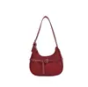 Elegante bolso de axila estilo francés para mujer, nuevo modelo 2025, bolso de media luna de diseño nicho, bolso versátil de un solo color para hombro y cruzado
