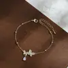 Pulsera de Joyería de Mano de Lujo Ligero con Circón Incrustado y Baño de Oro Real para Mujer, Pulsera con Colgante de Mariposa y Gota de Agua de Diseño Nicho al por Mayor