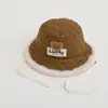 Orejeras de gorra Lei Feng para niños gorra niños y niñas bebé otoño e invierno a prueba de frío cálido sombrero de pescador color liso sombrero de cubo venta al por mayor