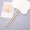 Cadena para teléfono de perlas estilo Chanel Colgante de flor pequeña Cordón para teléfono Funda para teléfono Accesorio con cuentas Cadena anticaídas para mujer