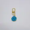 Comercio Electrónico Transfronterizo Aleación Colorido Cara Sonriente Esmaltada Llavero Chapado en Oro Expresión Asimétrica Accesorios Colgantes para Bolsos