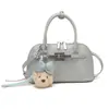 Bolso de Mano con Forma de Concha Estilo Coreano de Moda Transfronterizo para Mujer, Nuevo Modelo Verano 2026 con Decoración de Correa, Versátil Bolso de Hombro y Bolso Cruzado