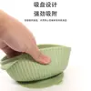 Tazón de alimentación para bebé de silicona de grado alimenticio con doble asa, diseño antiquemaduras y ventosa integrada para la autoalimentación infantil.