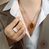 Moda Elegante Natural Estilo Tailandés Nanyang Colgante Ojo de Tigre Collar de Acero de Titanio Joyería con Cadena de Lana Otoño e Invierno