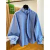 Camisa de mujer coreana de alta gama a rayas azules de manga larga, estilo nuevo de principios de primavera 2026, holgada y elegante, top de moda súper atractivo