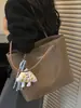 Bolso de color liso muy elegante de gran capacidad, nuevo modelo de verano 2026, bolso de hombro retro simple y chic, bolsa de mano para el trabajo