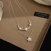 Collar con Colgante de Estrella de Perla y Circonita Apiladas de Doble Capa para Mujer Sensación de Alta Gama Lujo Ligero Nicho Cadena para Clavícula Nuevo Estilo 2026