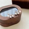 Elegantes pendientes de perlas de estilo nuevo, pendientes de perlas con sonrisa, luz explosiva, diseño de nicho de lujo, pendientes de alta gama para mujeres.