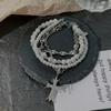 Pulsera moderna y moderna con cruz de perlas multicapa, diseño de nicho femenino, exquisita, dulce, atractiva, con personalidad de chica, a la moda, con gestos que combinan con todo.