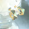 Moda griega retro todo-partido temperamento esmalte gota de aceite femenino nicho diseño original pendientes de botón pendientes de acero de titanio