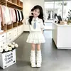 Nuevo conjunto dulce de dos piezas para niños de verano: nuevo vestido corto de manga corta con cuello polo para niñas con falda de pastel de encaje de doble capa