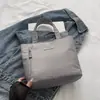 Mini Bolso 2026 Color Sólido Bolso de Mujer Repelente al Agua Bolsa Pequeña de Tela Bolso de Maquillaje a la Moda Bolso de Mano Sencillo para el Viaje