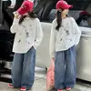Camiseta base de algodón puro para niña 2026 nuevo modelo camiseta de dibujos animados de manga larga con cuello redondo para niños top de otoño