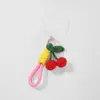 Explosiones transfronterizas moda coreana exquisita crochet a mano color cereza simulación cuerda de combinación llavero colgante para teléfono móvil