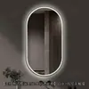 Espejo de baño inteligente ovalado en stock con lijado exterior e iluminación LED translúcida, adecuado para montaje en pared de baño y proyectos hoteleros, con opciones de personalización.