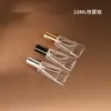 En stock Botella de perfume de vidrio transparente estilo pasta de dientes de 10 ml, botella con atomizador de presión, botella dispensadora cosmética portátil de pequeña capacidad